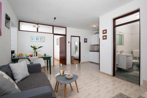 a living room with a couch and a table at House ingrid in Pula