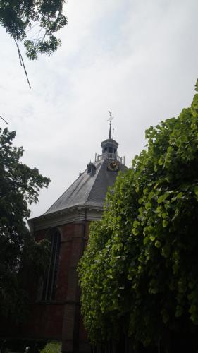 a church with a cross on top of a roof at Hotel Willemstad in Willemstad