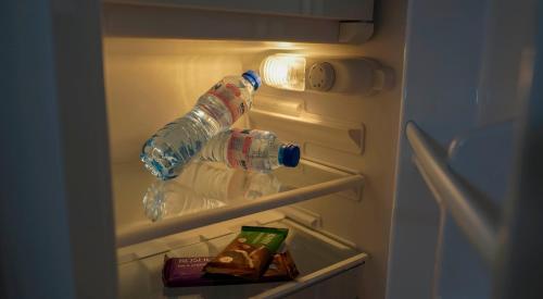 two bottles of water in an open refrigerator at Tatyana Guest House in Byala