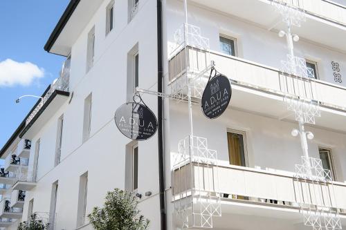 a white building with two signs on the side of it at Adua & Regina di Saba Wellness & Beauty in Montecatini Terme