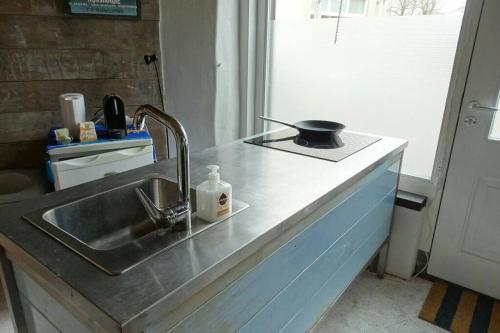 a kitchen sink with a pan on top of it at Studio in Arnhem