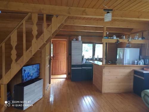 a large kitchen with a staircase in a cabin at Przystanek Bieszczady in Stańkowa