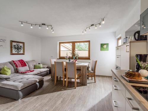 uma cozinha e sala de estar com uma mesa e um sofá em Restaurant Appartements Almdiele em Hart im Zillertal