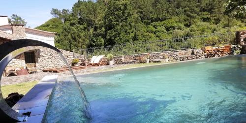 a swimming pool with a water fountain at Rio d'Azenha - Country House in Roliça