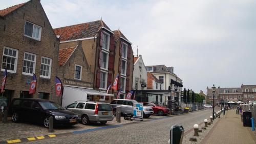 a street with cars parked on the side of the road at Hotel Willemstad in Willemstad