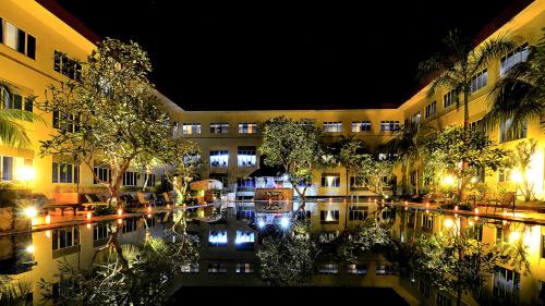 a building with a pool of water at night at Aston Tanjung Pinang Hotel & Conference Center in Tanjung Pinang 