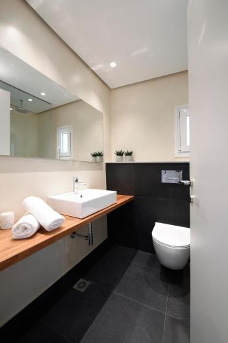 a bathroom with a sink and a toilet at m2studio in Kavala