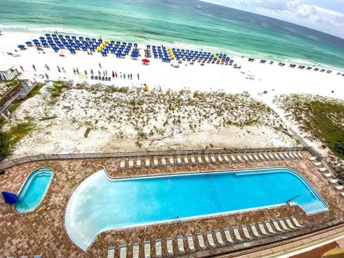 an overhead view of a swimming pool next to a beach at Pelican Beach Resort Condos in Destin