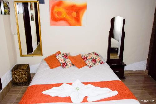 A bed or beds in a room at Pousada das Acerolas