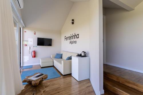 a living room with a couch and a table at Gavião Nature Village in Gavião