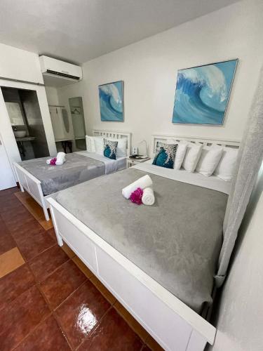 two beds in a room with two at La Jamaca - An Island Vibe Hotel in La Parguera