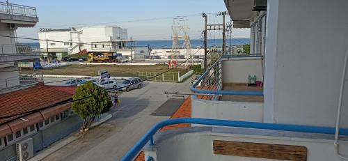 a balcony of a building with a view of the ocean at Studio near the port !!! in Paralia Katerinis