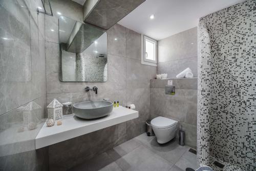 a bathroom with a sink and a toilet and a shower at Stavros Villas in Karterados