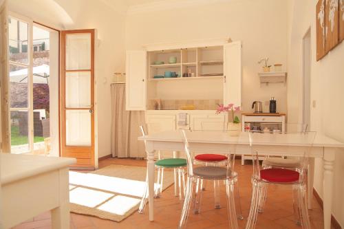 a kitchen with a table and four chairs at La Corte di Lisa - Self check-in in Pisa