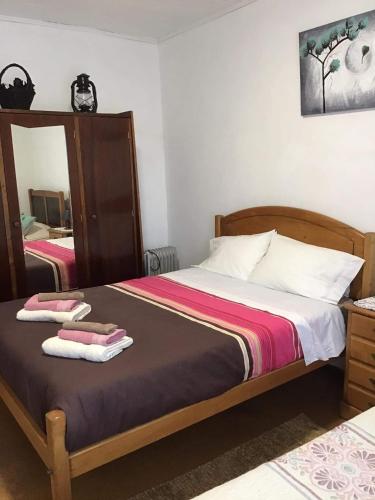 a bedroom with a bed with two towels on it at Casa J Dias in Nordeste