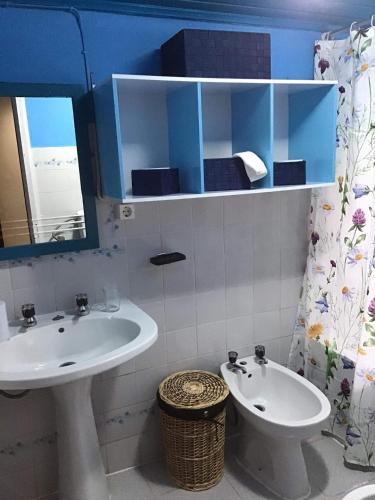 a bathroom with a sink and a toilet and a mirror at Casa J Dias in Nordeste