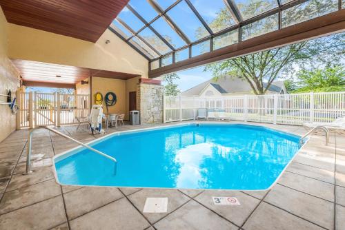a swimming pool in a house with a large window at Red Roof Inn Columbus - Grove City in Grove City