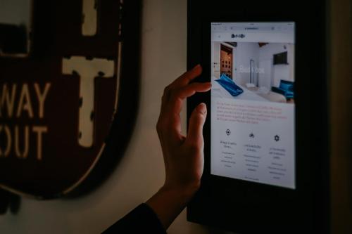 a person holding up a ipad in front of a mirror at Bed and Box - VT02 Locazione turistica in Viterbo