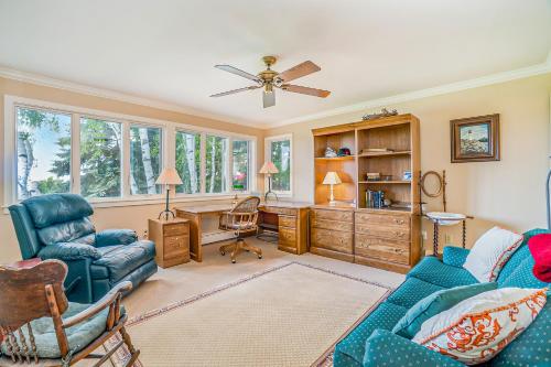 a living room with a blue couch and a desk at Birchwood: Meadows Bliss in Harbor Springs