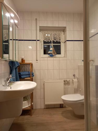 a bathroom with a sink and a toilet at Ferienwohung Charlotte in Usedom Town