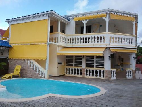 a house with a swimming pool in front of it at Villa Mancina in Capesterre-Belle-Eau