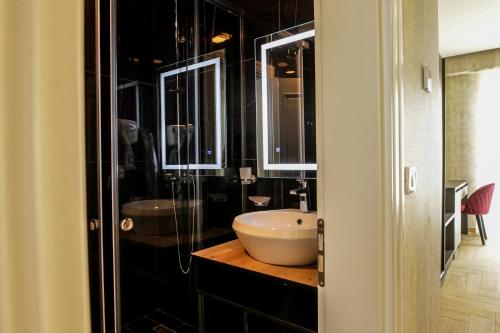 a bathroom with a sink and a glass shower at Rozafa Blu Hotel in Shëngjin