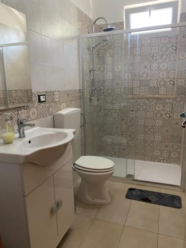 a bathroom with a toilet and a shower and a sink at B&B Villa Grazia in Pulsano