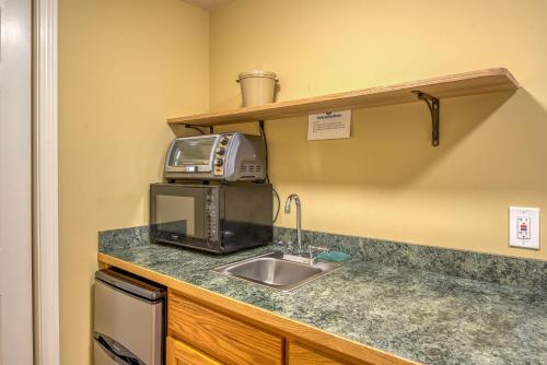 a kitchen counter with a microwave and a sink at Purity Spring Resort in Madison