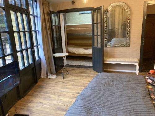 a bedroom with a bed and a mirror and a bunk room at Canal Central in Bruges