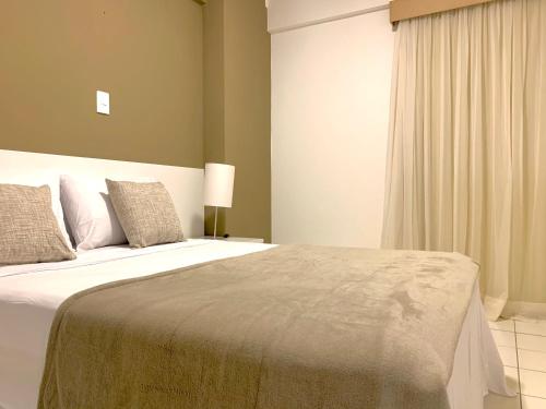 a bedroom with a large bed in a room at Biarritz temporadalitoranea in São Luís
