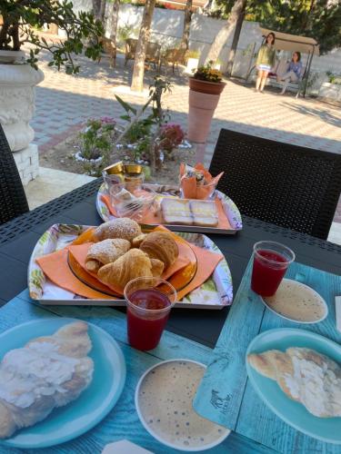 a blue table with plates of food on it at B&B Villa Grazia in Pulsano