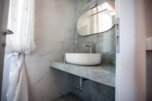 a bathroom with a sink and a mirror at Cavalieri D'Oro Luxury House in Anzio