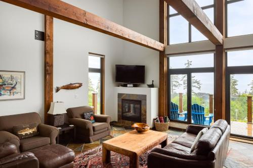 a living room filled with furniture and a fireplace at Black Rock Ridge in Ucluelet