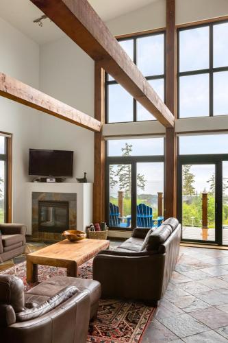 a living room with couches and a fireplace at Black Rock Ridge in Ucluelet