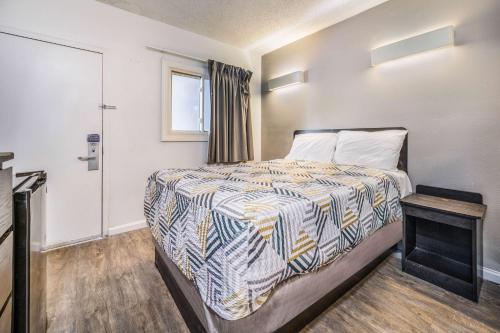 a small bedroom with a bed and a window at Motel 6-Toms River, NJ in Toms River