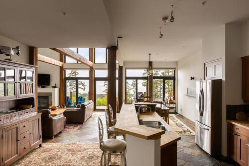 a kitchen and living room with a large window at Black Rock Ridge in Ucluelet