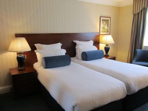 a hotel room with two beds and two lamps at Windmill Village Hotel, Golf Club & Spa, BW Signature Collection in Coventry