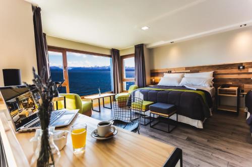 a hotel room with a bed and a view of the ocean at Hotel Eco Max in San Carlos de Bariloche