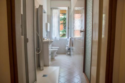 a white bathroom with a toilet and a sink at FLY HOUSE BOLOGNA...un appartamento al volo in Bologna