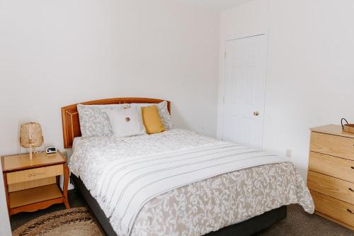 a bedroom with a bed and a nightstand and a bed sidx sidx sidx sidx at Blue Moon Motel in Lake George