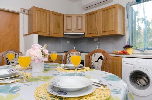 a kitchen with a table with glasses of orange juice at Apartments Ivana in Murter