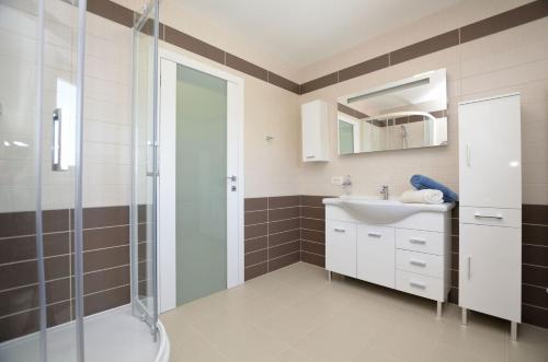 a bathroom with a shower and a sink at Apartments Villa Sofia in Martinšćica