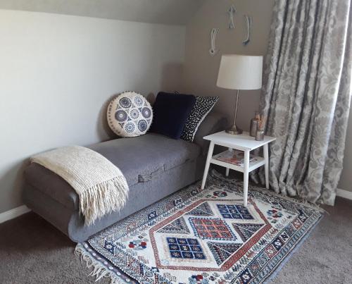 a living room with a couch and a table at No. 6 Heathcote in Taupo