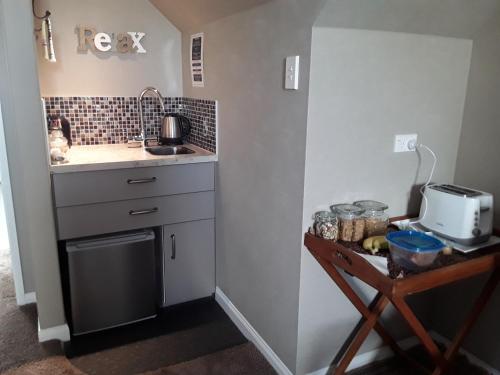 a small kitchen with a sink and a counter at No. 6 Heathcote in Taupo