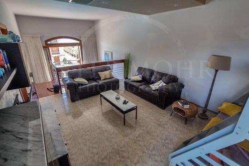 a living room with a couch and a table at Fort Chambray Harbor Breeze in Għajnsielem