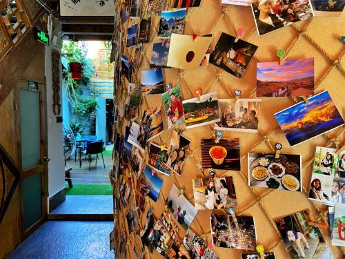 a wall full of pictures on a wall at Juxian Boutique Homestay in Lijiang