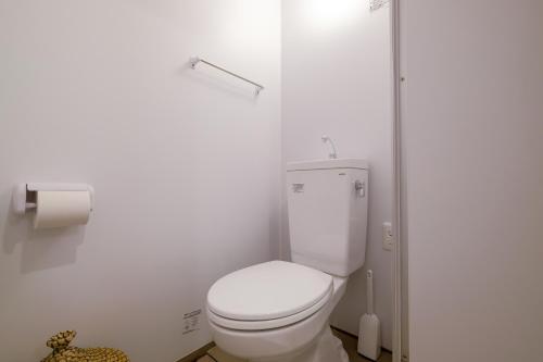 a bathroom with a white toilet in a room at Le Soleil Asato in Naha