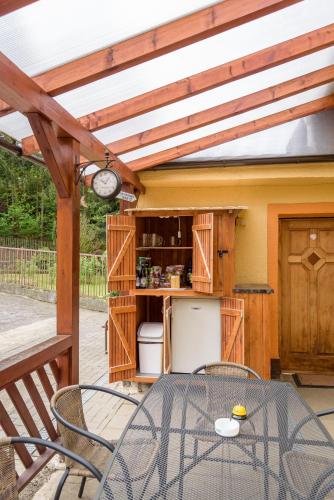 a patio with a table and chairs on a deck at Agroturistika - "Domeček u oveček" in Horní Těrlicko