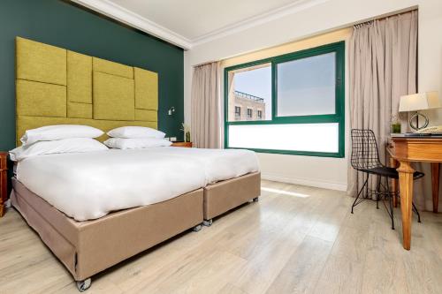 A bed or beds in a room at Ye'arim Hotel