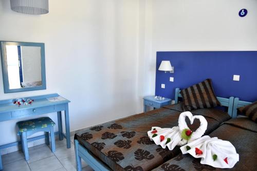 a room with a couch and a table and a mirror at 1-Bedroom Kos Olympia Apartment at Lambi beach in Kos Town